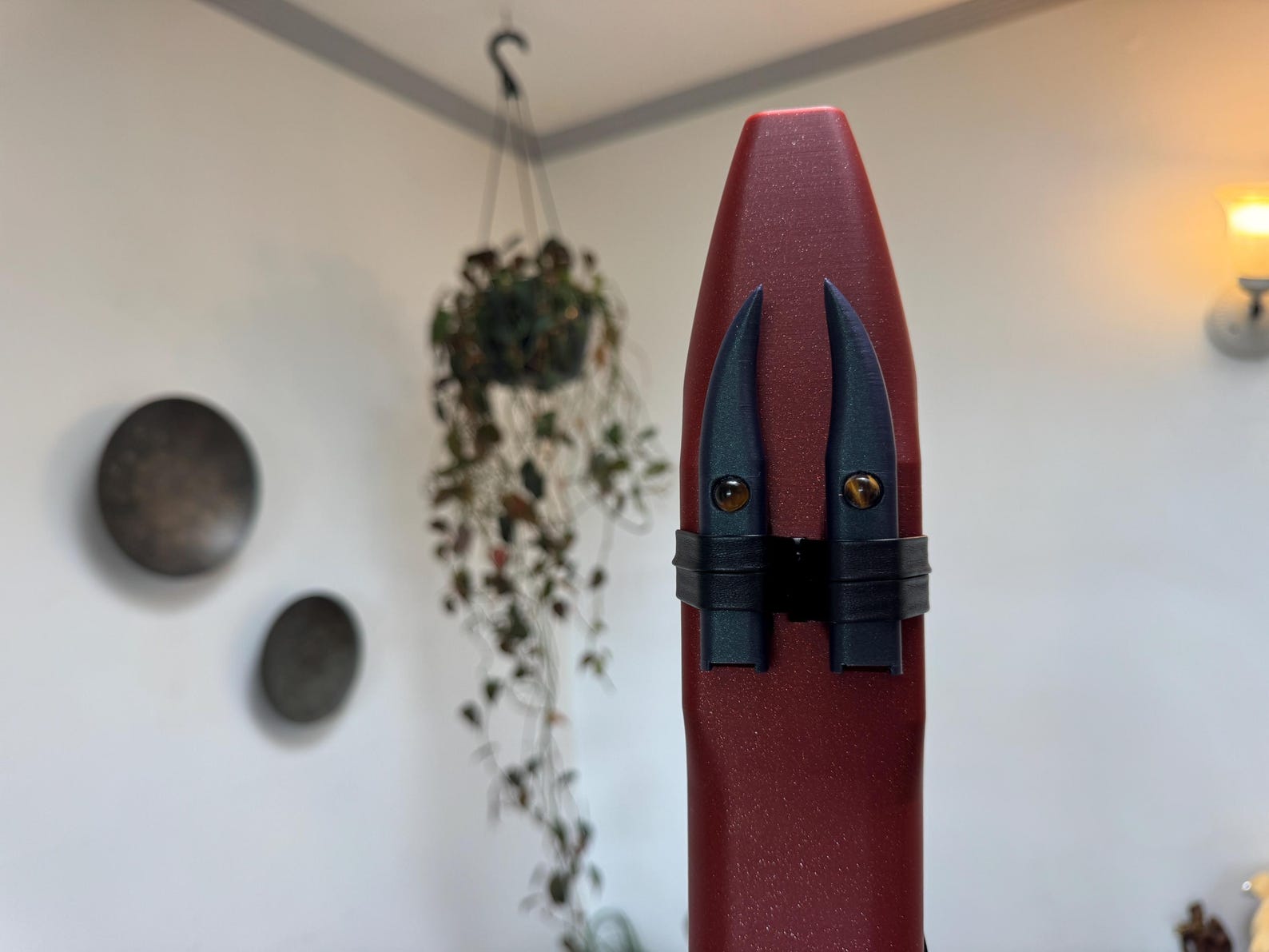 Close-up of the two drone-chamber birds with tiger-eye accents
