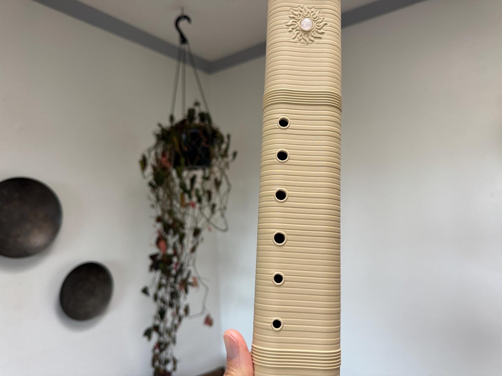 The six finger holes running down the ridged melody side of the Desert Rose drone flute