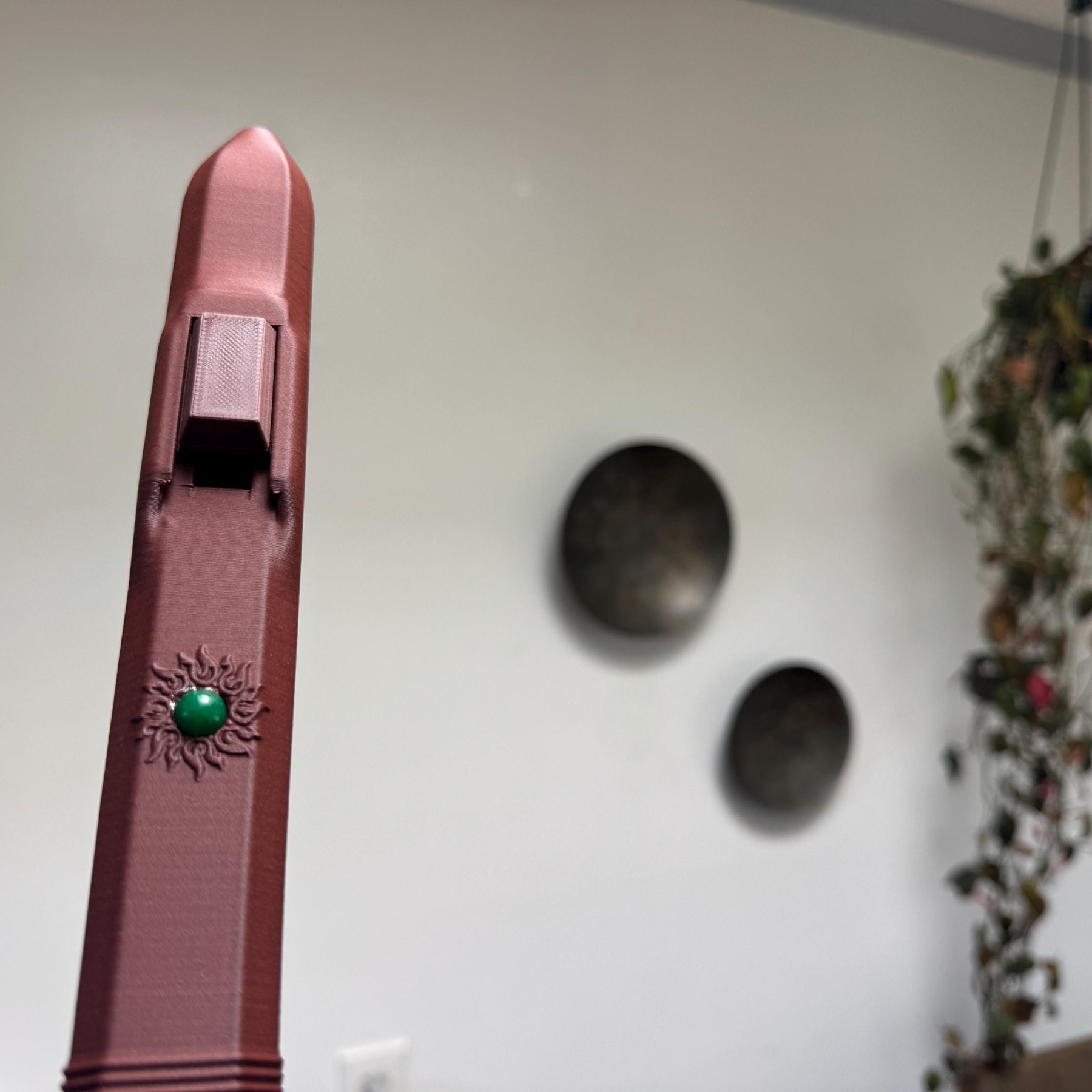 Upright view of the flute mouthpiece and block with the green stone sun emblem