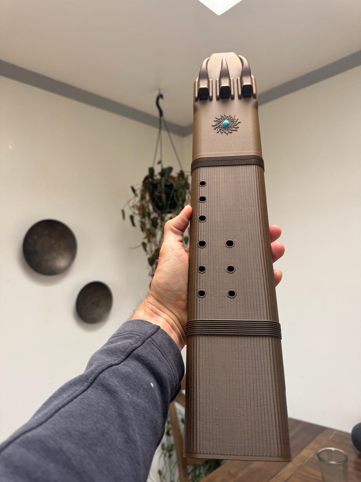F sharp 4 triple drone flute held in one hand, showing the rib-textured playing section and its two rows of finger holes